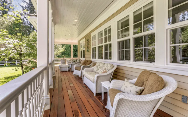 Stained wood deck with white balusters